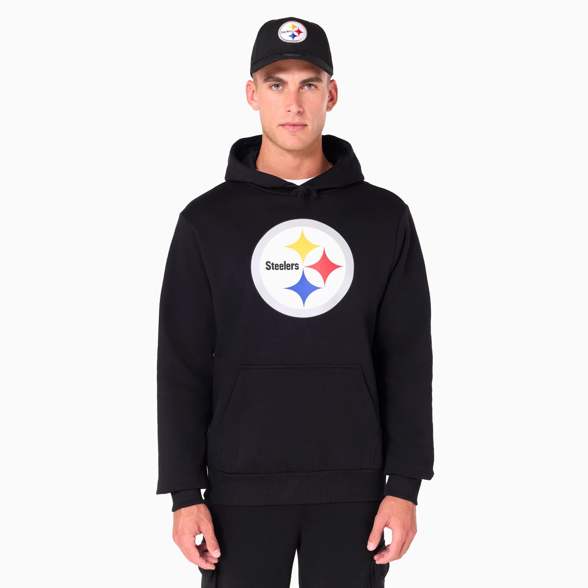 New Era Pittsburgh Steelers NFL Black Pullover Hoodie, on-model front view showing the large circular team logo printed on the chest and a kangaroo pocket below, paired with a matching black cap featuring a raised logo.