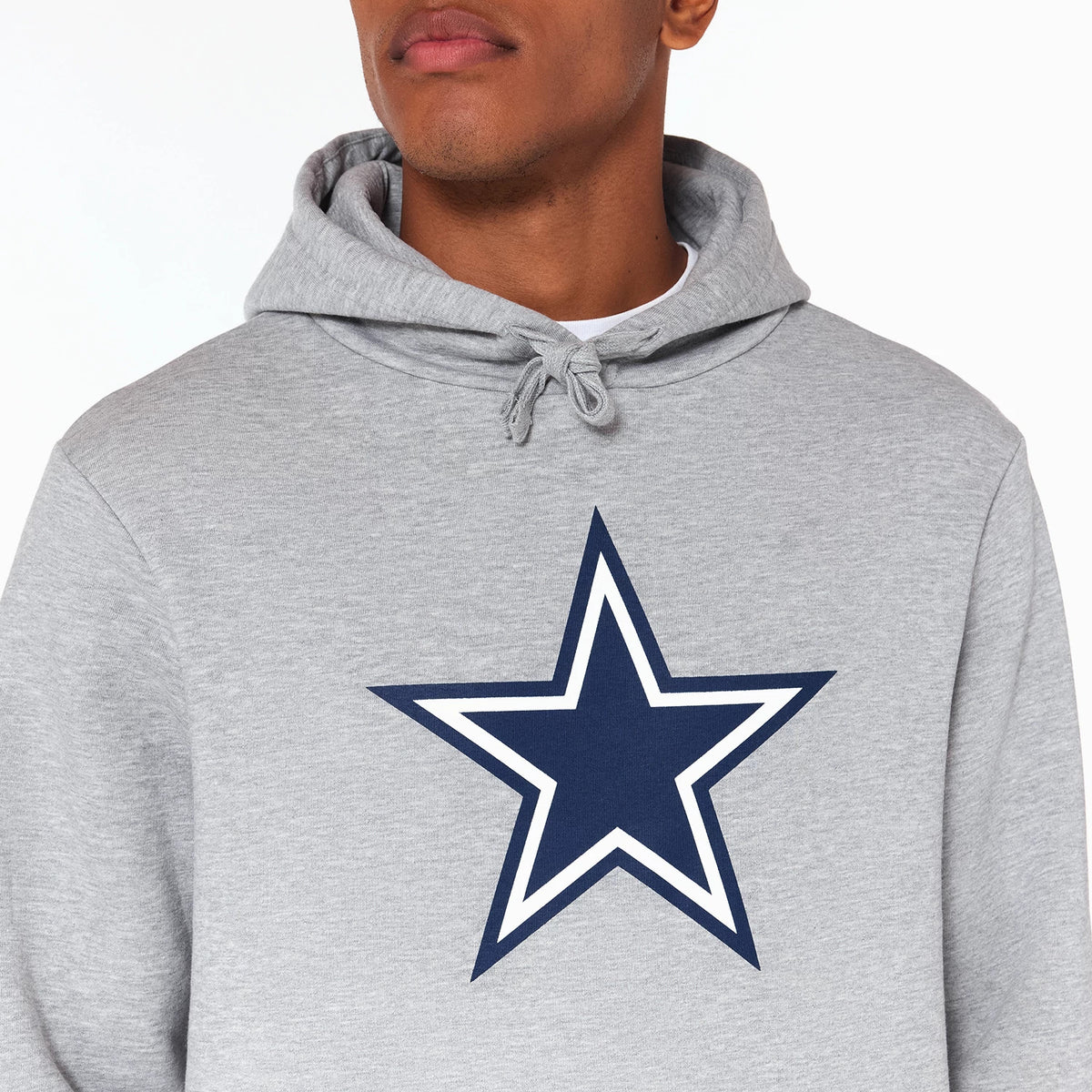 New Era Dallas Cowboys NFL Grey Pullover Hoodie, front view showing the large printed navy star logo with a white outline centred on the chest, drawstrings at the neck, and the light grey fabric of the hoodie.