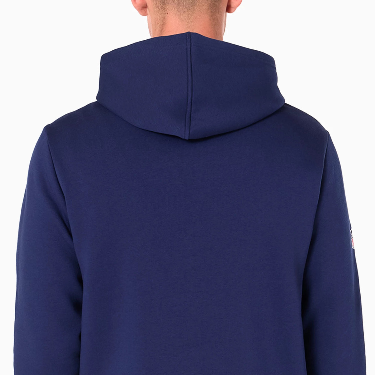 New Era Tennessee Titans NFL Navy Pullover Hoodie, rear view showing the plain navy back with a spacious hood, seams running vertically down the shoulders and a small emblem visible on the left sleeve edge.