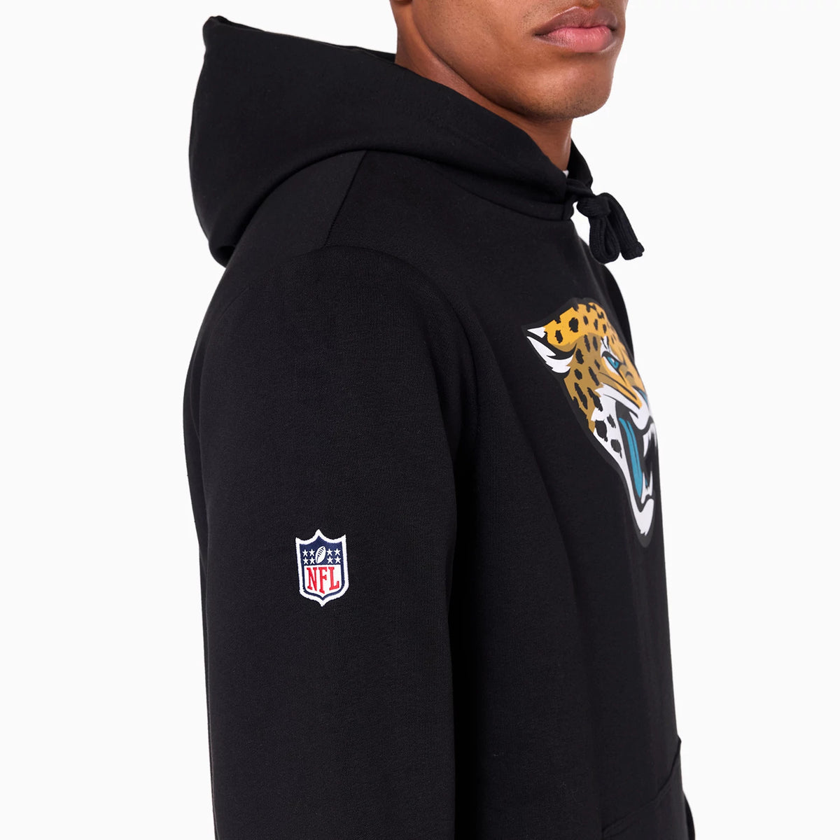 New Era Jacksonville Jaguars NFL Black Pullover Hoodie, side view showing the black hoodie with a large Jacksonville Jaguars logo on the chest and an embroidered NFL logo patch on the sleeve.