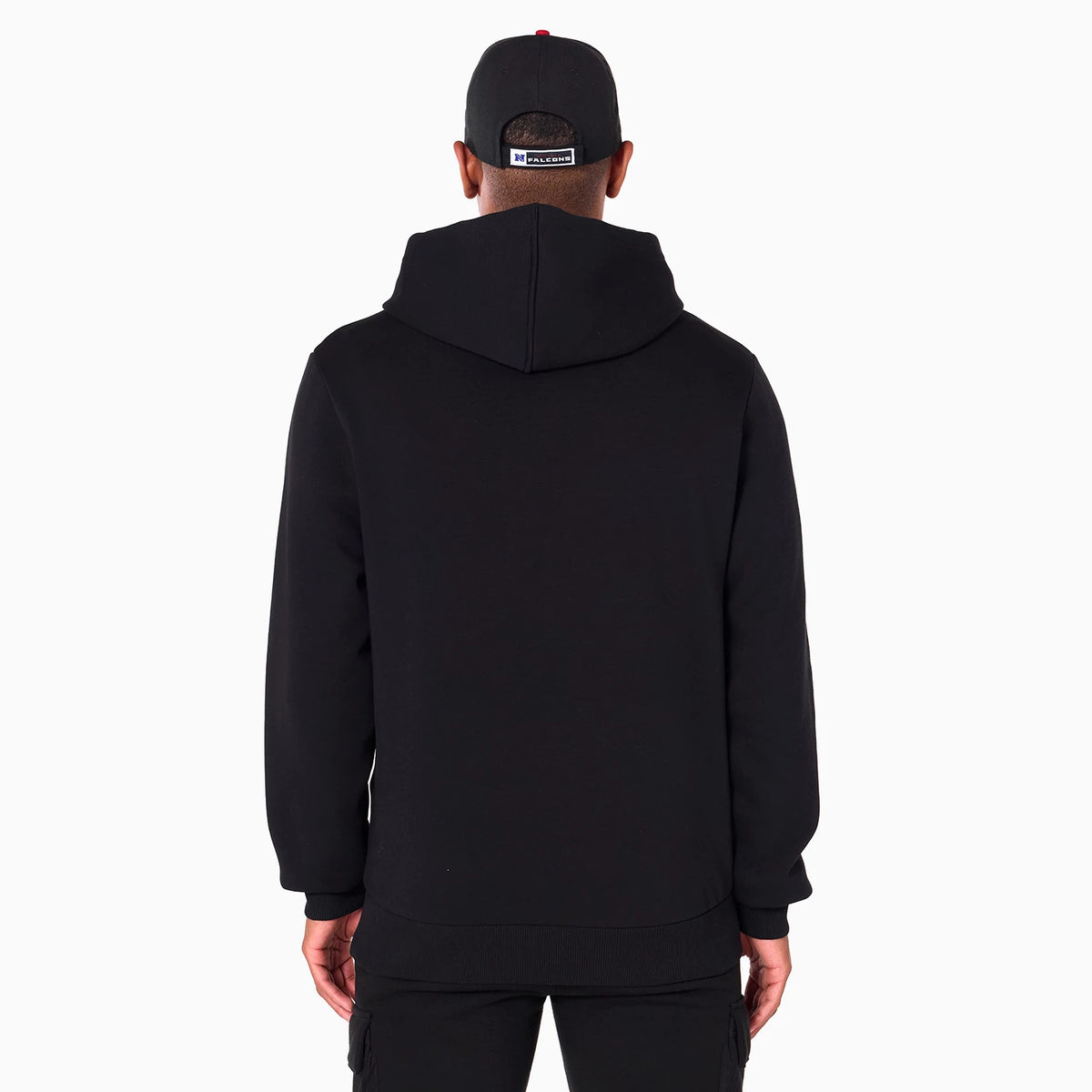 New Era Atlanta Falcons NFL Black Pullover Hoodie, rear view showing a plain black hood resting on the shoulders, long sleeves with cuffs, and a black cap with a debossed Falcons logo on the back of the cap.