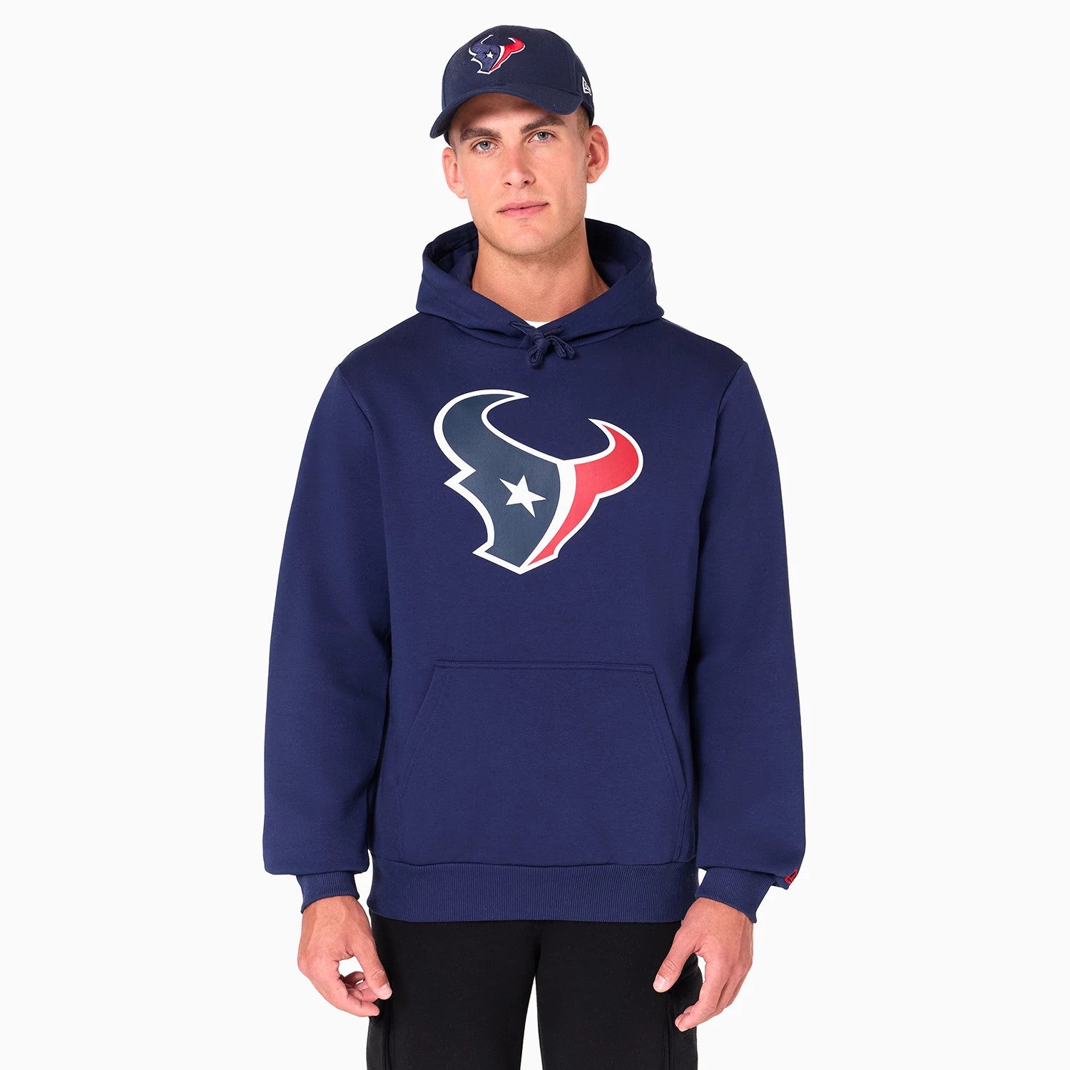 New Era Houston Texans NFL Navy Pullover Hoodie, on-model view showing the large Texans logo in red, white, and blue on the chest, featuring a kangaroo pocket and an adjustable drawstring hood, paired with a navy cap also displaying the team logo.