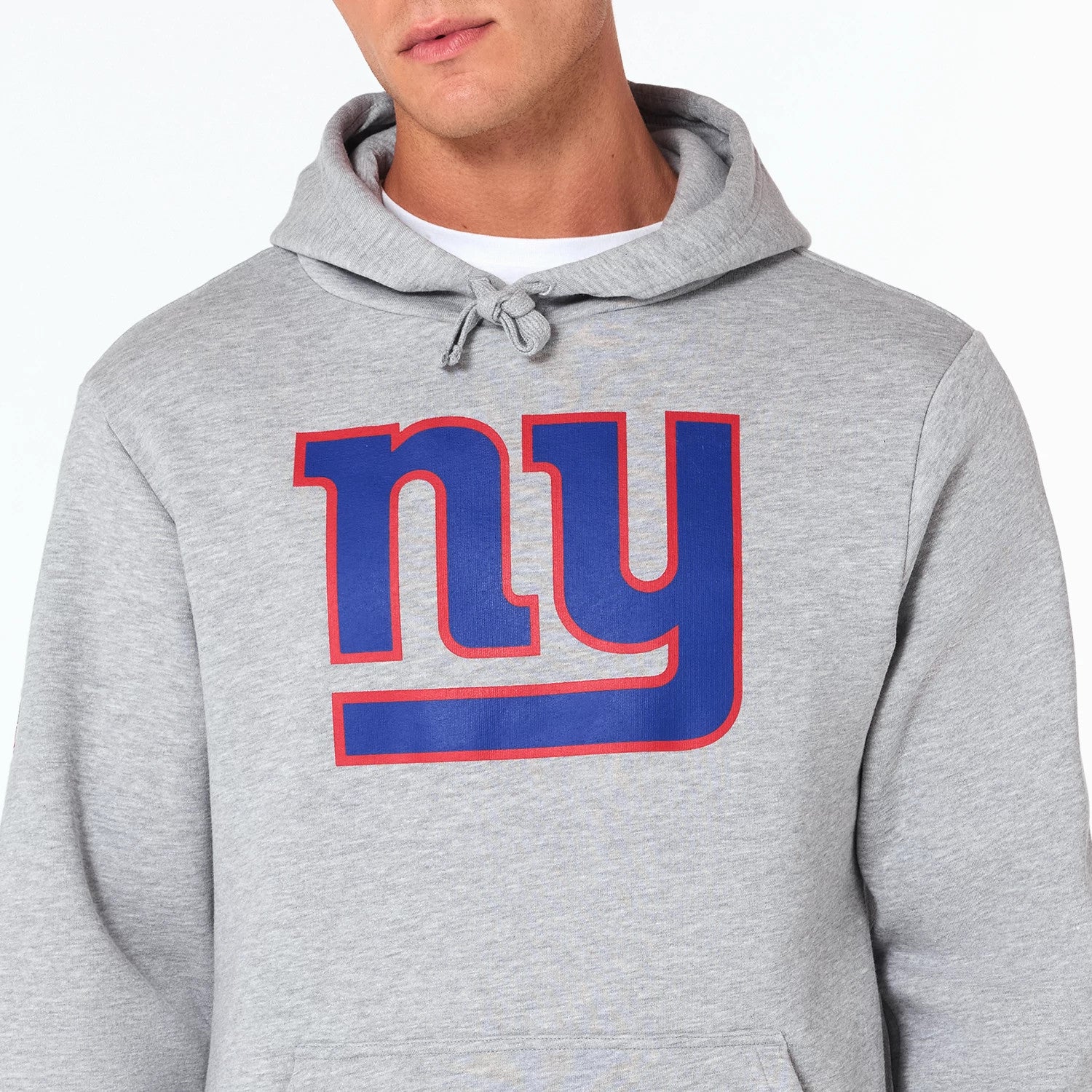 New Era New York Giants NFL Grey Pullover Hoodie, front view showing the grey hoodie with a large blue ny logo outlined in red on the chest and an adjustable drawstring hood above.