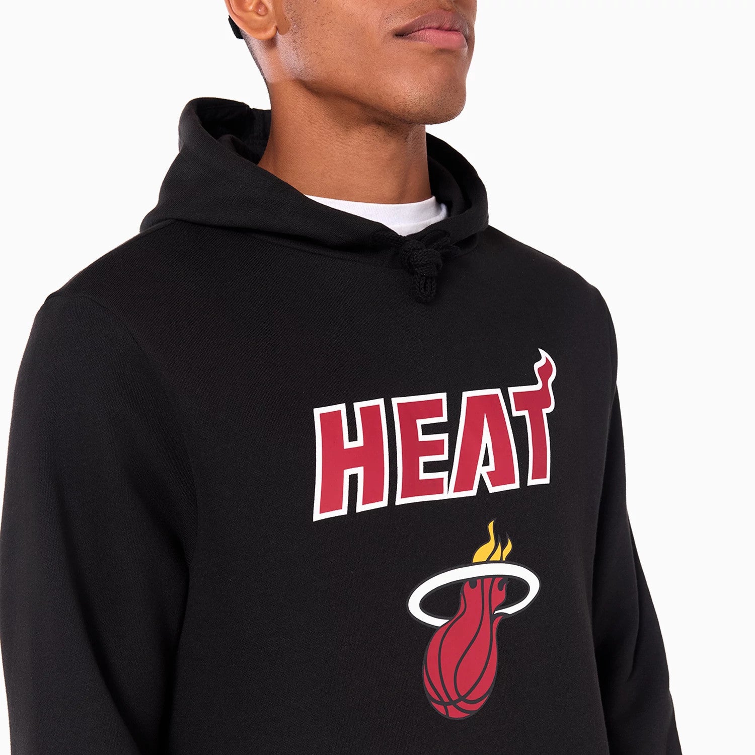 New Era Miami Heat NBA Black Pullover Hoodie, front view showing the embroidered Miami Heat logo in red and white centred on the chest, with a drawstring hood and a close-up of the top half of the hoodie.