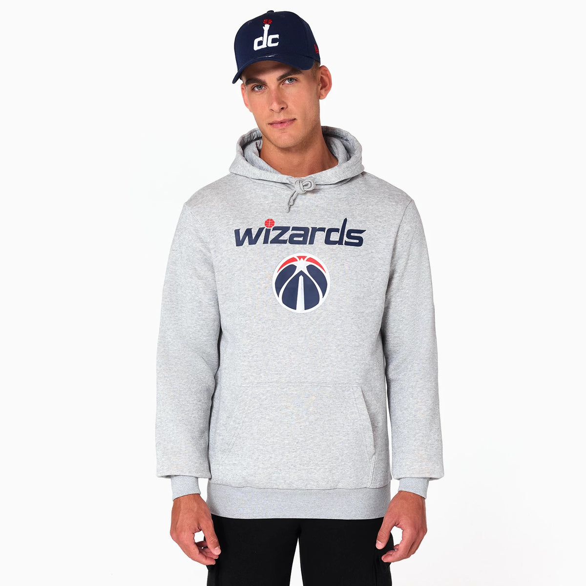 New Era Washington Wizards NBA Grey Pullover Hoodie, on-model view showing the grey hoodie with large front pocket, blue and red Wizards logo and text across the chest, worn with a navy cap featuring a white dc design.