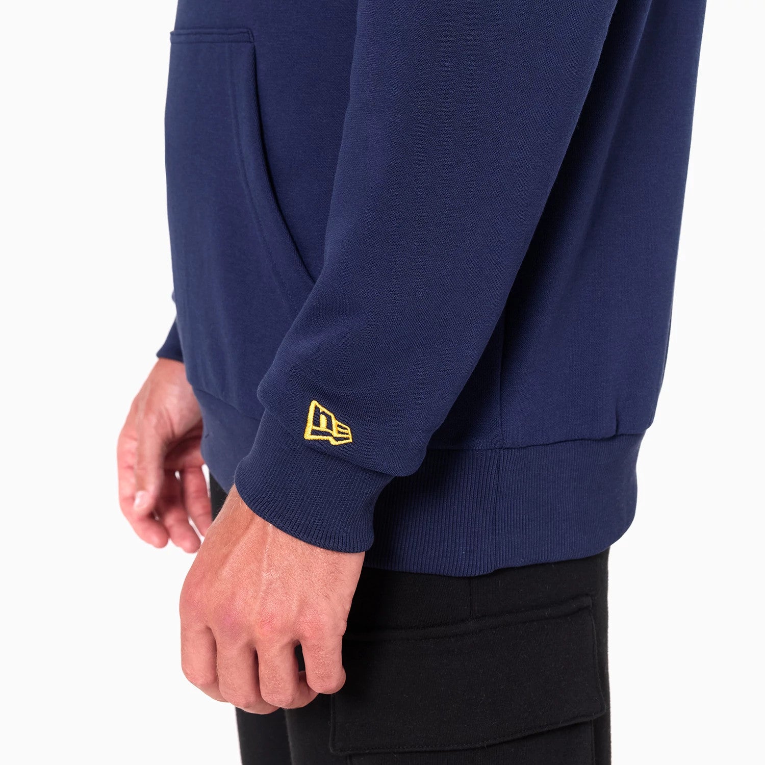 New Era Denver Nuggets NBA Navy Pullover Hoodie, side view showing the cuff with a raised yellow New Era logo on the left sleeve, the kangaroo pocket on the front and the ribbed hem.