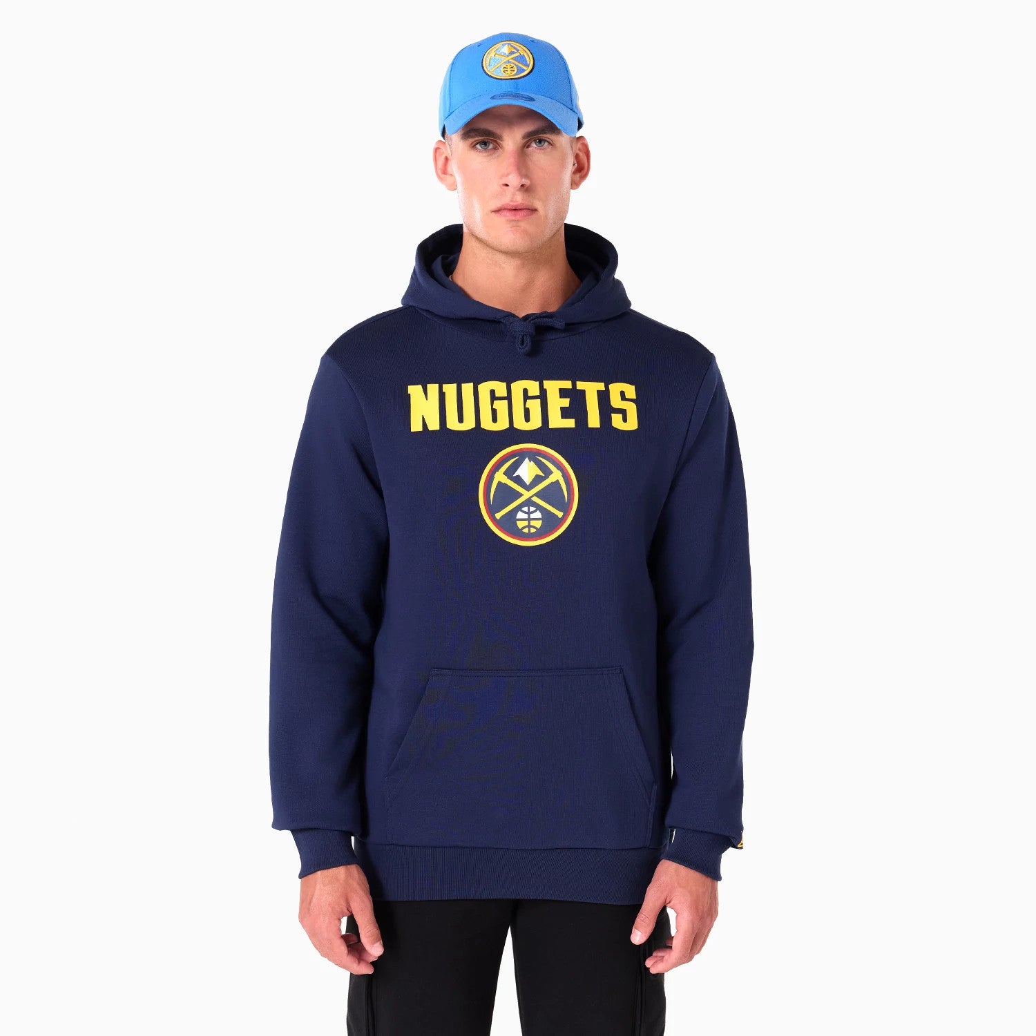 New Era Denver Nuggets NBA Navy Pullover Hoodie, on-model view featuring the large yellow NUGGETS text across the chest with the team logo beneath, paired with a blue cap displaying the same logo, showing the fit and design.