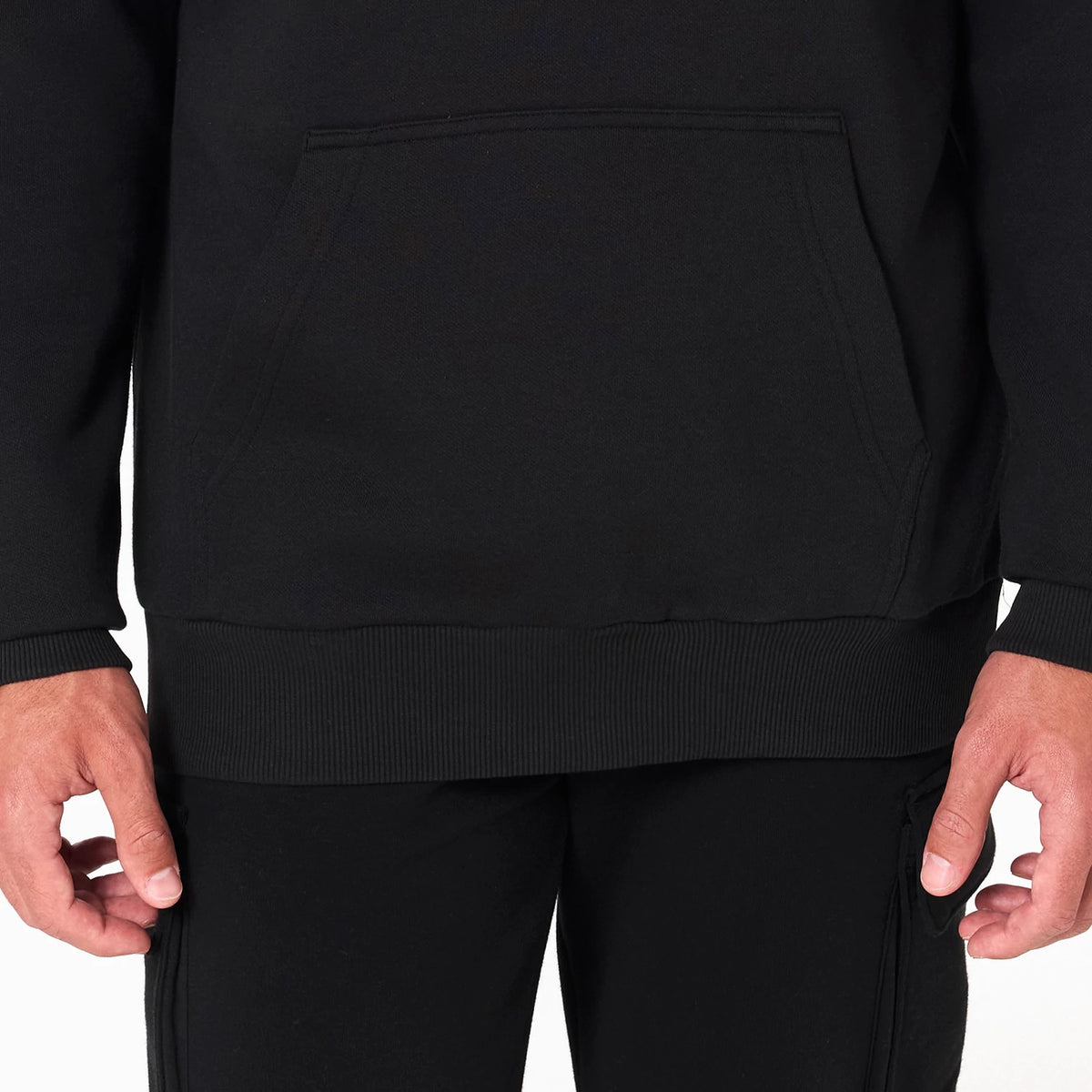 New Era LA Clippers NBA Black Pullover Hoodie, front view showing the plain black fabric with a large kangaroo pocket on the lower front, ribbed cuffs and hem, and long sleeves extending to the wrists.