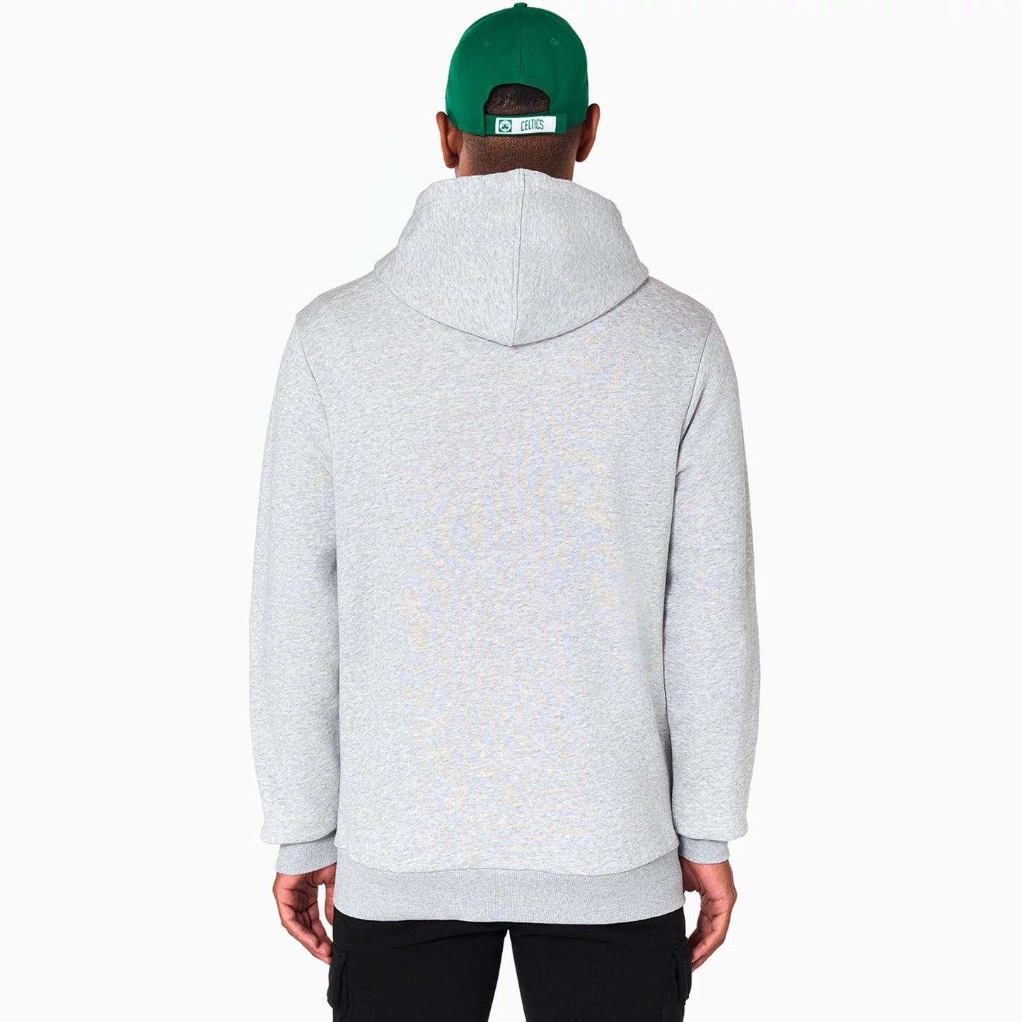 New Era Boston Celtics NBA Grey Pullover Hoodie, rear view showing the plain light grey back with a relaxed fit, attached hood draping down, and long cuffed sleeves, on a model wearing a green cap.