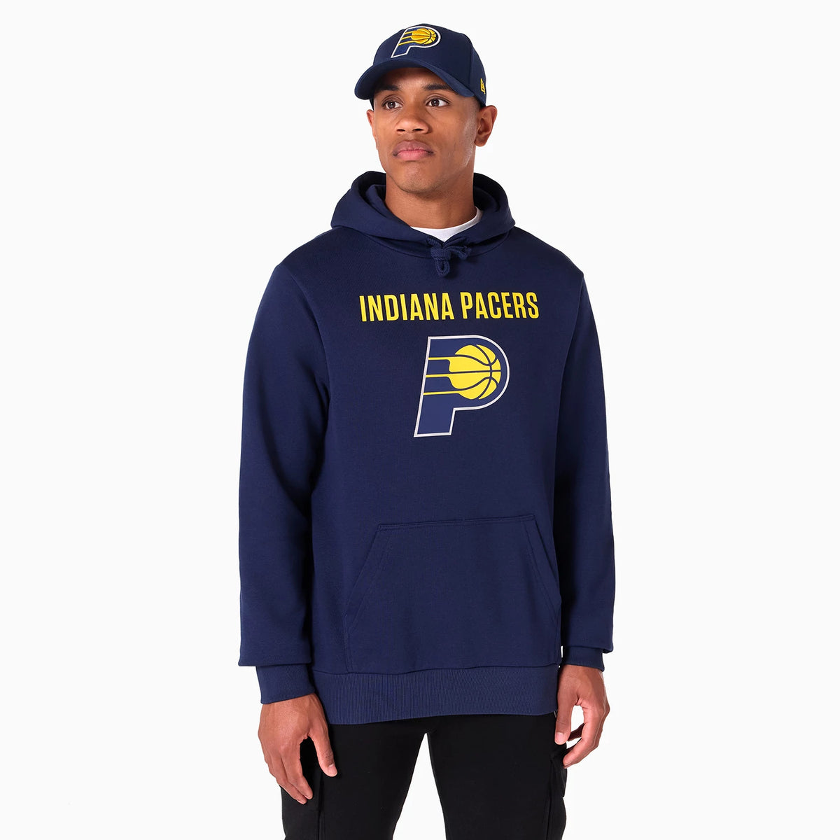 New Era Indiana Pacers NBA Navy Pullover Hoodie, on-model view showing the navy hoodie with a drawstring hood, yellow Indiana Pacers text and logo across the chest, paired with a matching navy cap displaying a raised team logo.