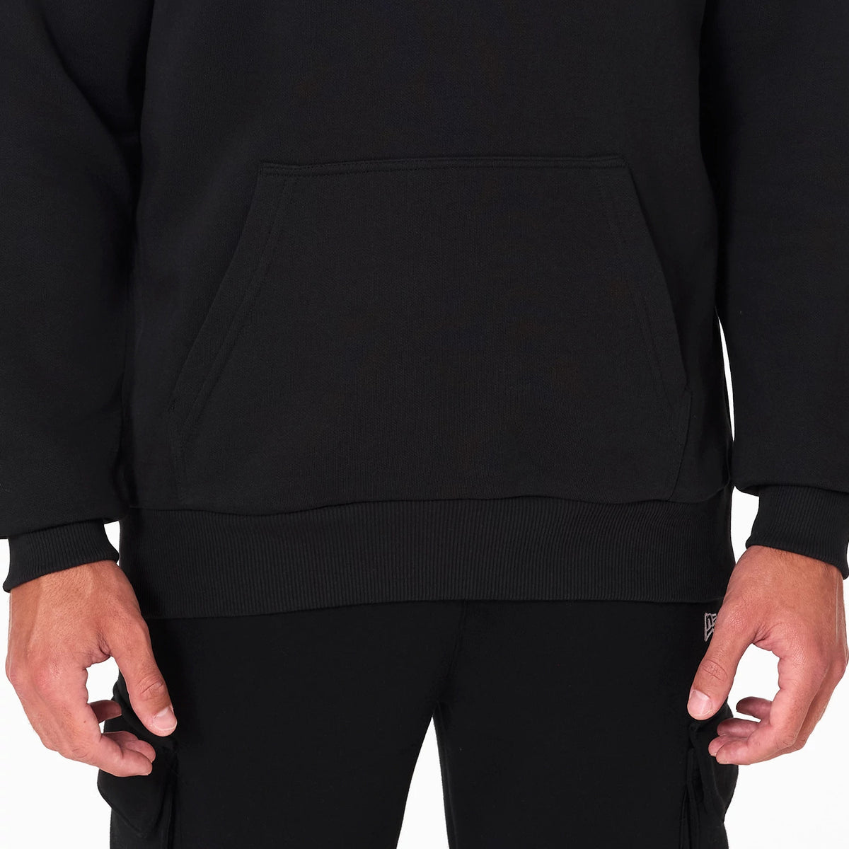 New Era Minnesota Timberwolves NBA Black Pullover Hoodie, front view showing the kangaroo pocket on the lower half, ribbed hem and cuffs, and a miniature debossed New Era logo on the left sleeve near the wrist.