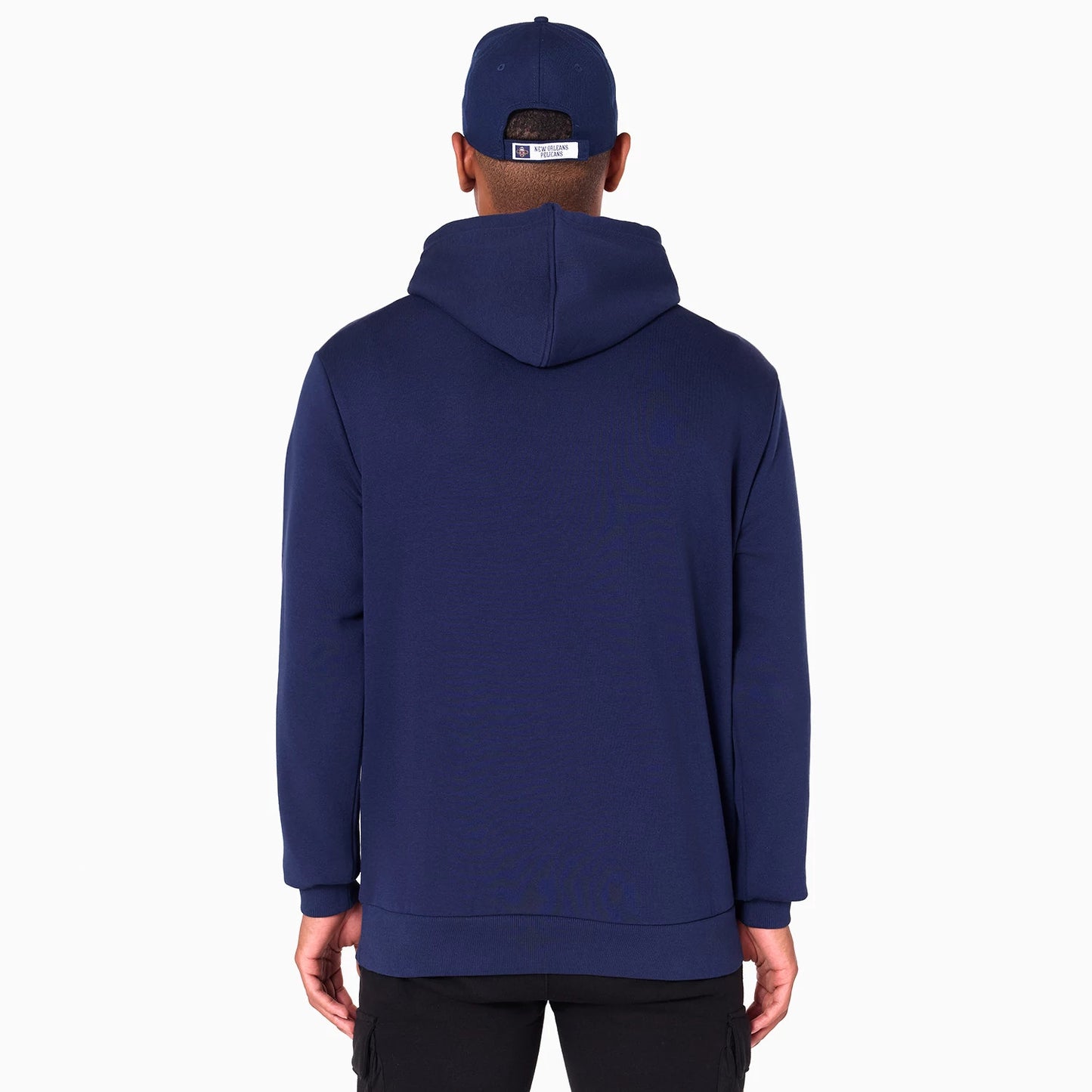 New Era New Orleans Pelicans NBA Navy Pullover Hoodie, rear view showing the navy hood and back, with the person wearing a navy cap featuring a raised New Era logo on the back strap.