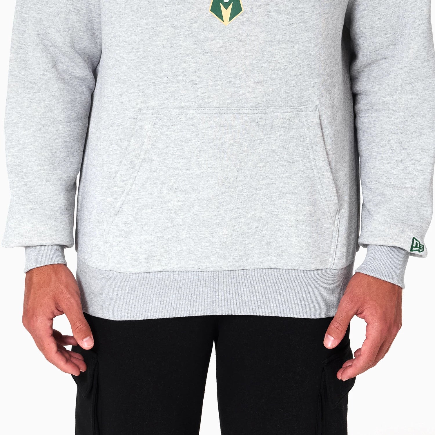 New Era Milwaukee Bucks NBA Grey Pullover Hoodie, front view showing the grey fabric with a large kangaroo pocket on the lower front, a small debossed logo on the left sleeve cuff and part of a large team emblem on the chest.