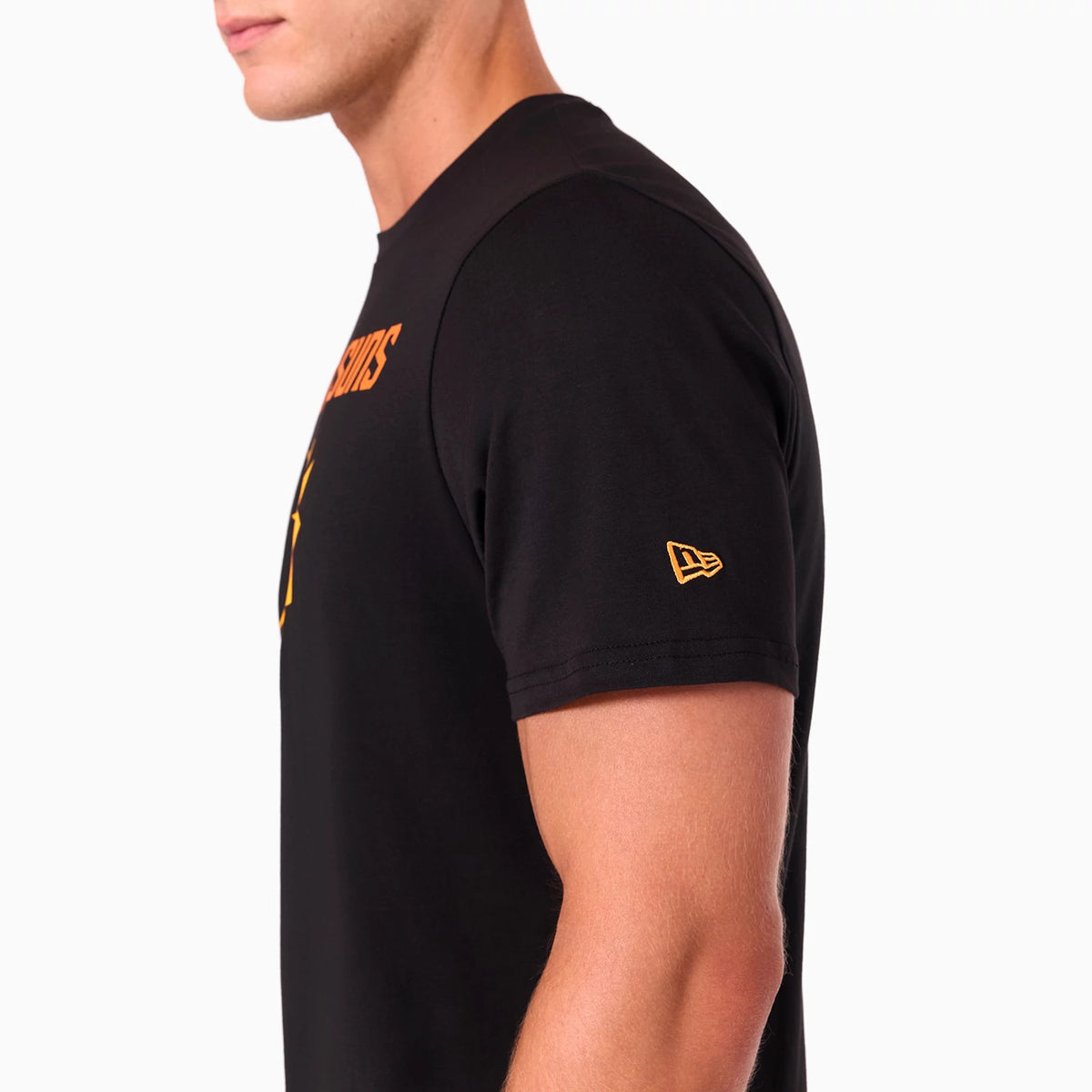 New Era Phoenix Suns NBA Black T-Shirt, side view showing a black sleeve with a raised yellow New Era logo near the cuff and part of the orange text logo on the chest extending from the front.