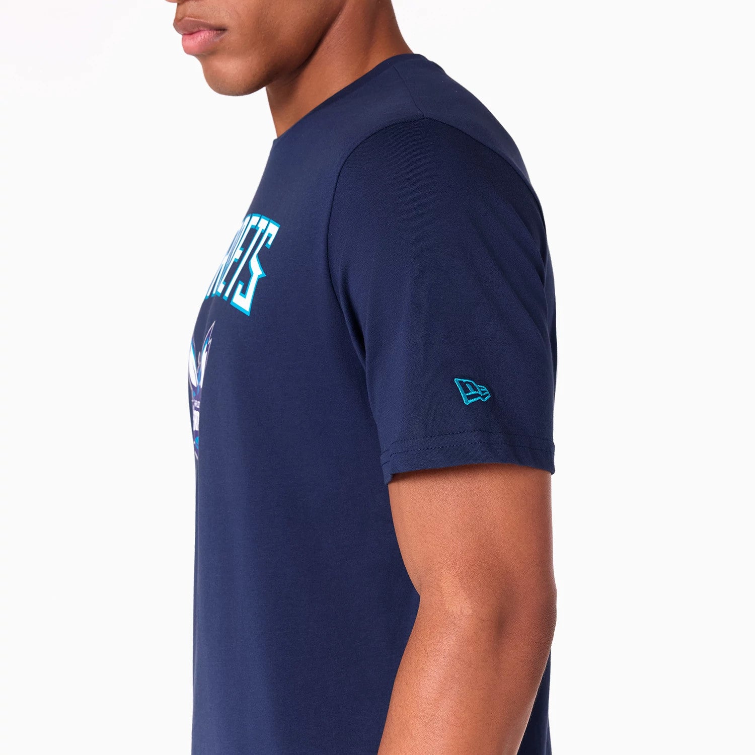 New Era Charlotte Hornets NBA Navy T-Shirt, side view showing a raised New Era logo on the sleeve and part of the team’s name and mascot graphic on the front, with a fitted navy design.