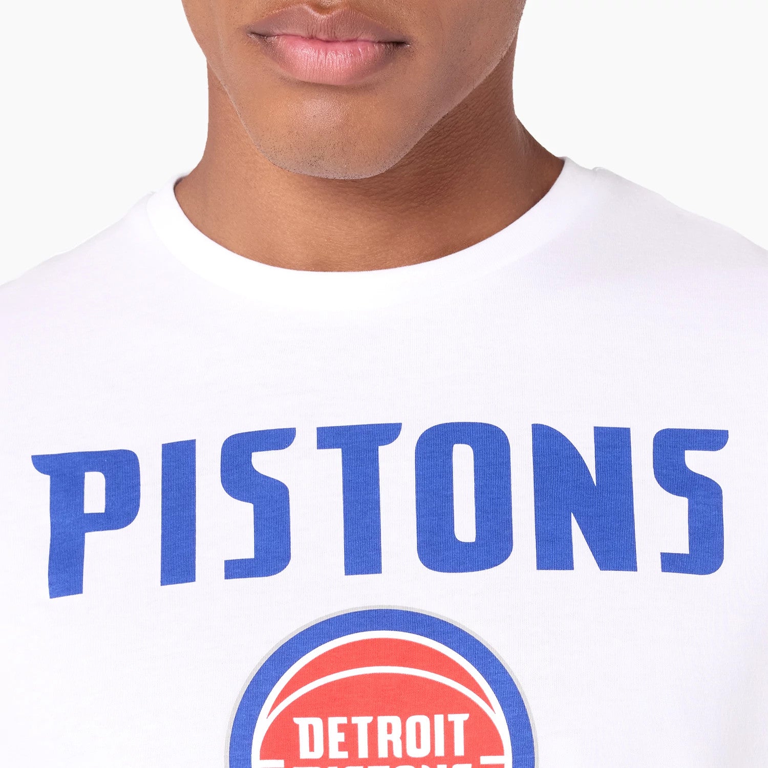 New Era Detroit Pistons NBA White T-Shirt, front close-up showing the bold blue 'PISTONS' text across the chest, with the Detroit Pistons red and blue basketball logo debossed below it on the white fabric.