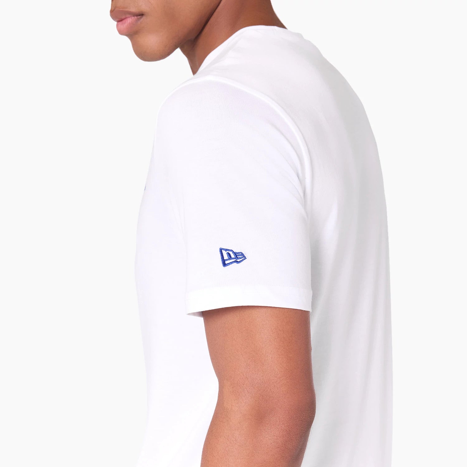 New Era Detroit Pistons NBA White T-Shirt, side view showing the plain white sleeve adorned with a blue embroidered New Era logo on the cuff, highlighting the clean and minimalist design of the shirt against the arm.