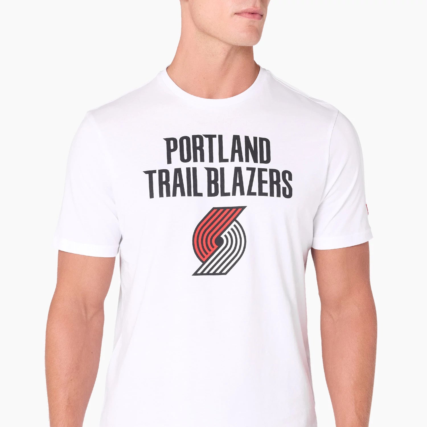 New Era Portland Trail Blazers NBA White T-Shirt, front view showing the team name in bold black lettering across the chest above the red and black team logo on a plain white background, worn by a model.