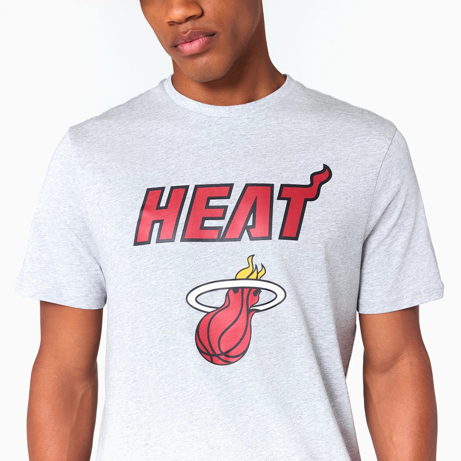 New Era Miami Heat NBA Grey T-Shirt, front view showing the red and black HEAT text with a flaming basketball logo beneath, both centrally printed on the chest of the light grey fabric.