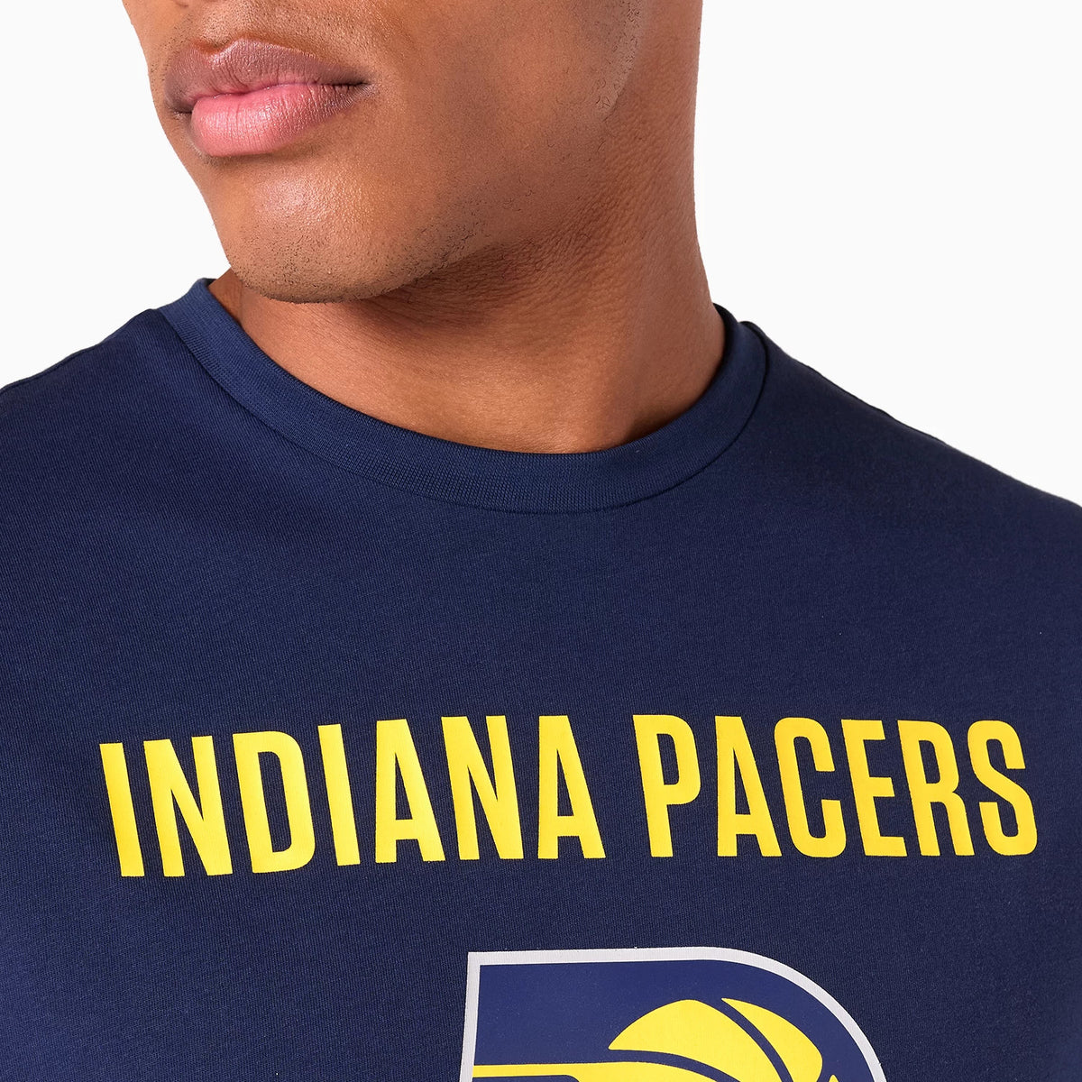 New Era Indiana Pacers NBA Graphic Navy T-Shirt, front view showing a bold yellow INDIANA PACERS text across the chest above a large graphic logo, highlighting the high contrast design on a navy fabric.
