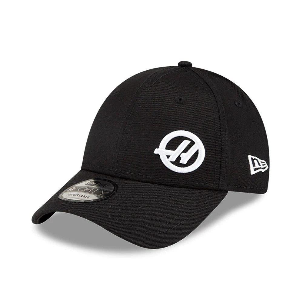 TGR Haas F1 Team Flawless Black New Era 9FORTY Adjustable Cap, front view showing the white embroidered logo on the front panel, the curved visor with a 9FORTY size sticker, and the New Era flag logo on the left side.