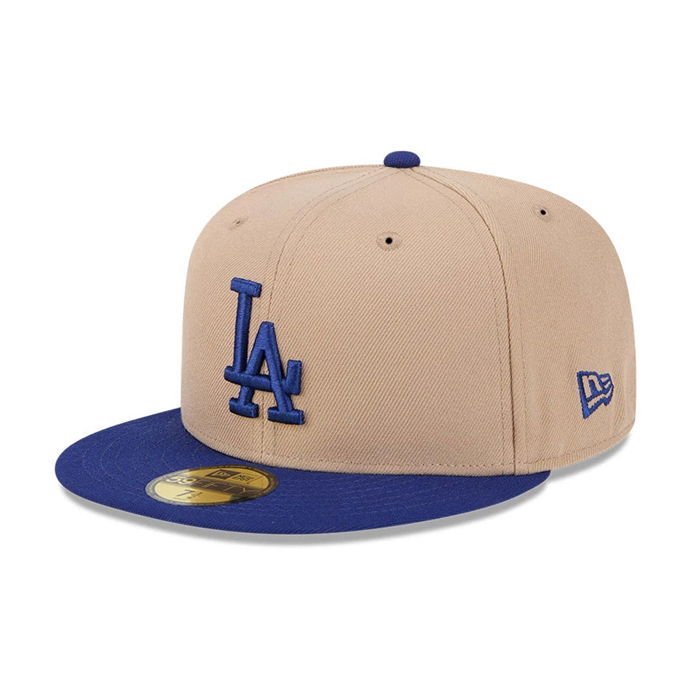 LA Dodgers MLB Evergreen Light Beige New Era 59FIFTY Fitted Cap, three-quarter view showing the raised blue LA logo on the front panel, royal blue visor with gold 59FIFTY size sticker, and New Era flag logo on the left side.