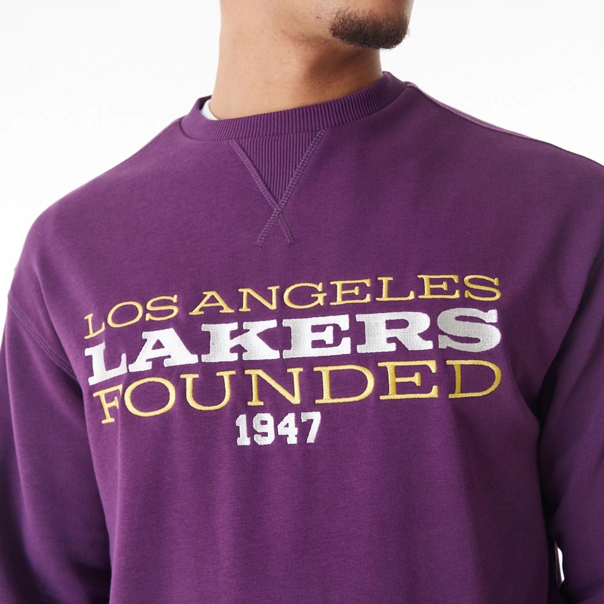 The Male model is wearing LA Lakers NBA Lifestyle Dark Purple Oversized Crew Neck Sweater 1