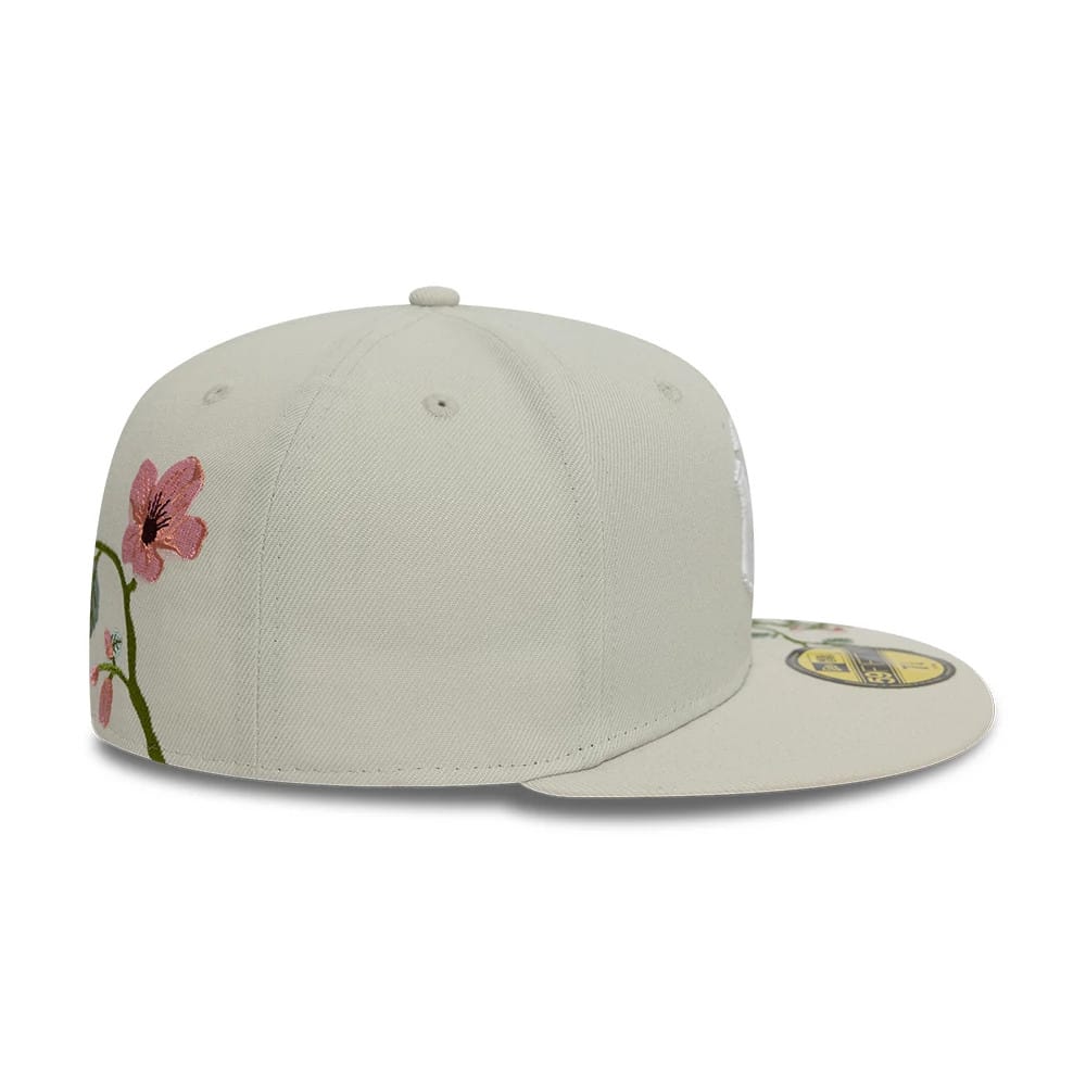 New York Yankees MLB Floral Light Beige New Era 59FIFTY Fitted Cap, side view showing pink floral embroidery on the left panel and a gold 59FIFTY size sticker on the light beige flat visor.