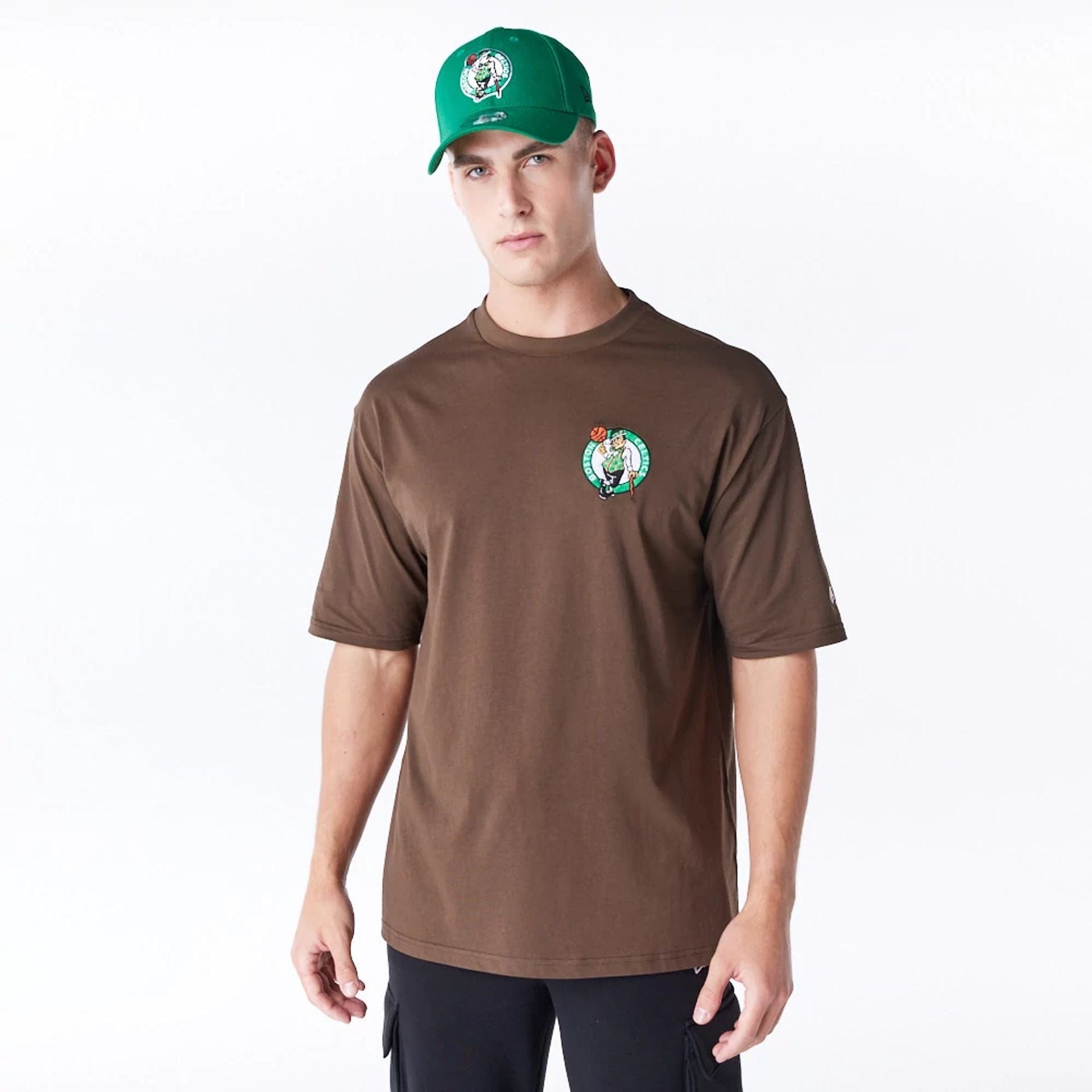 The Male model is wearing Boston Celtics League Essential Dark Brown Oversized T-Shirt 1
