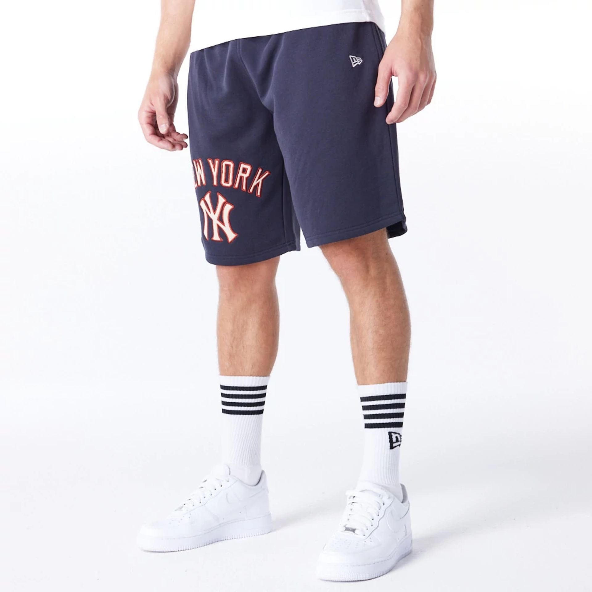 The Male model is wearing New York Yankees MLB Lifestyle Navy Shorts 2