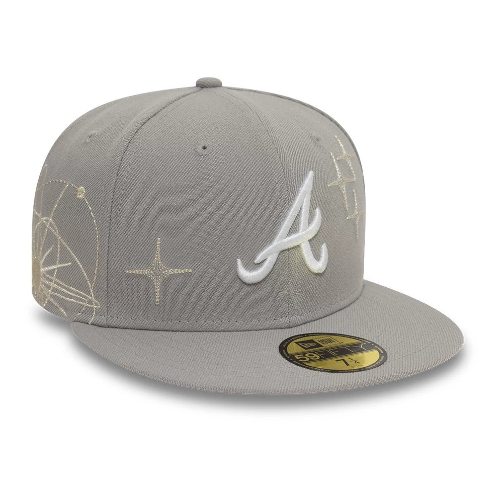 Atlanta Braves MLB Zodiac Grey New Era 59FIFTY Fitted Cap, three-quarter view showing the white embroidered A logo on the front panel and gold astronomical pattern embroidery on the side, with a gold 59FIFTY size sticker on the grey visor.