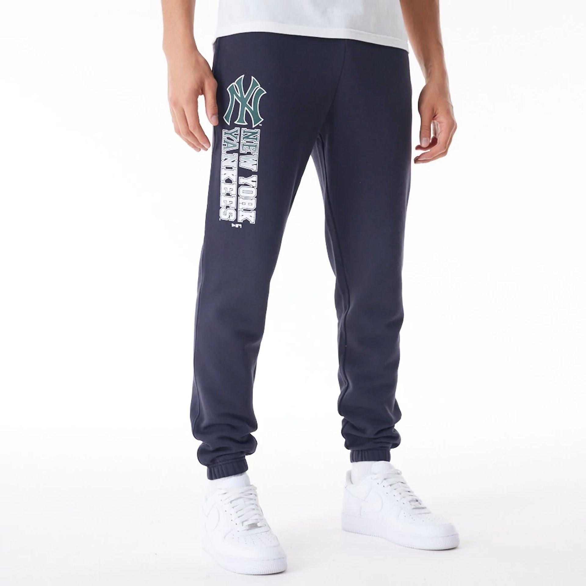 The Male model is wearing New York Yankees MLB Gradient Graphic Navy Joggers 1