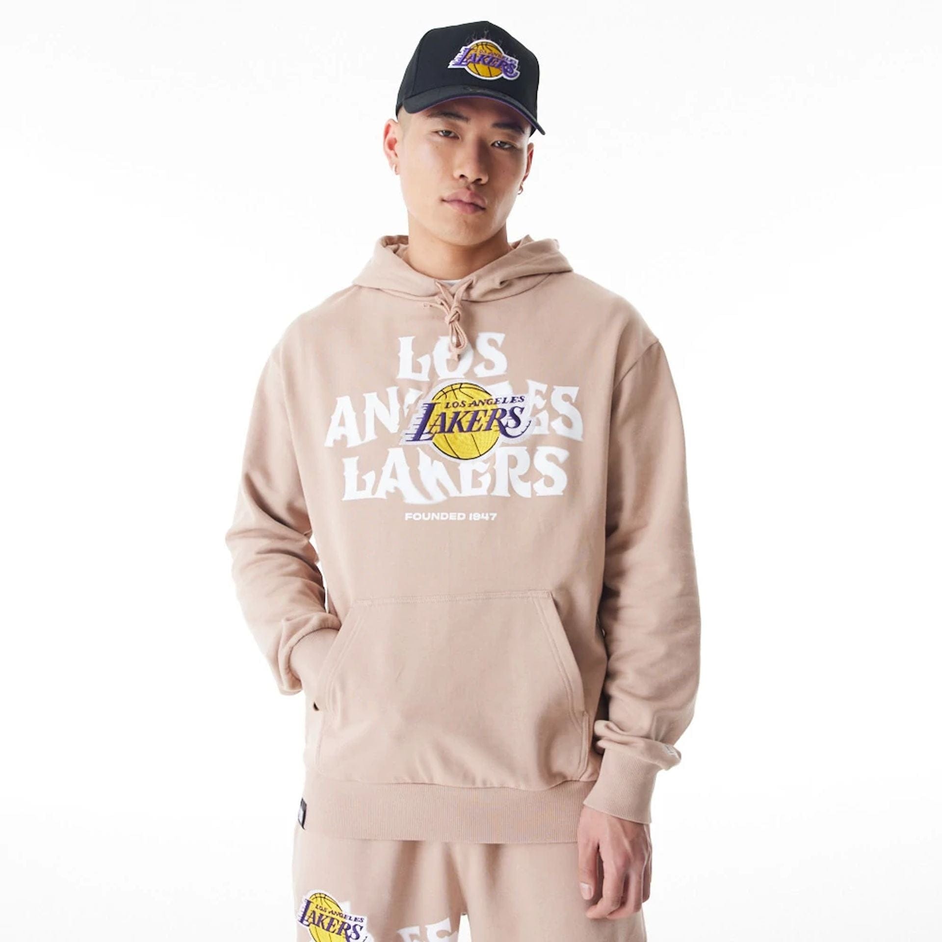 The Male model is wearing LA Lakers NBA Graphic Beige Oversized Pullover Hoodie 1