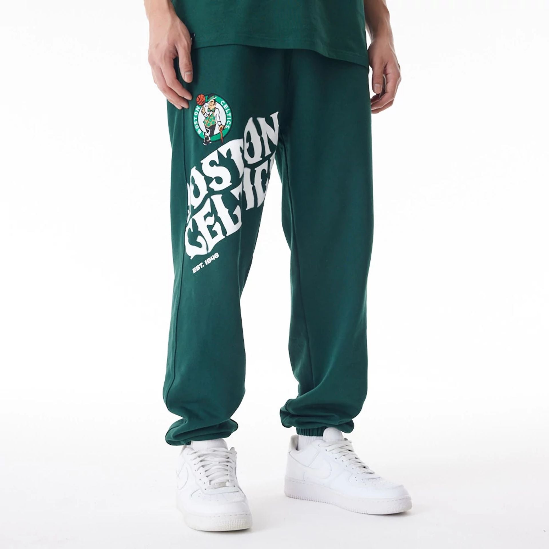 The Male model is wearing Boston Celtics NBA Graphic Dark Green Joggers 1