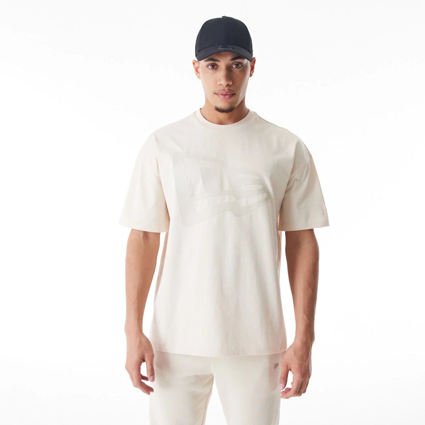 The Male model is wearing New Era Flag Cream Oversized T-Shirt 6