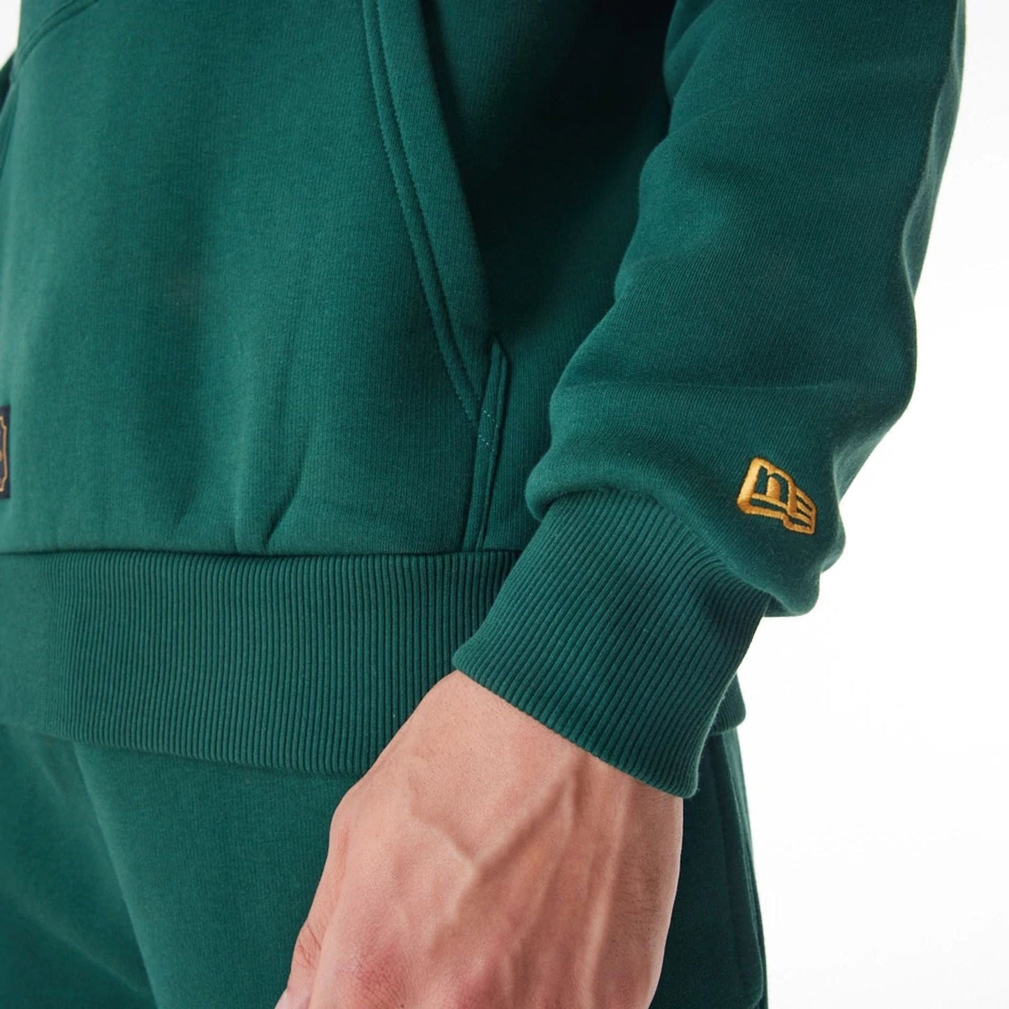 The Male model is wearing New Era Script Logo Dark Green Oversized Pullover Hoodie 12