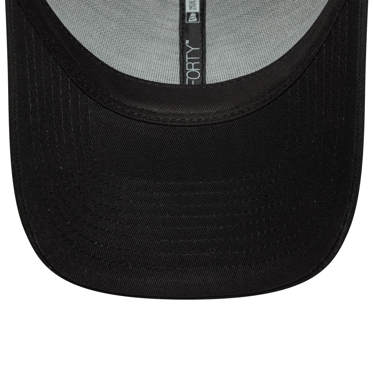 Newcastle United FC Core Black New Era 9FORTY Adjustable Cap, inside view showing the grey undervisor, white sweatband, and black taping with 9FORTY labelling running along the crown's seam.