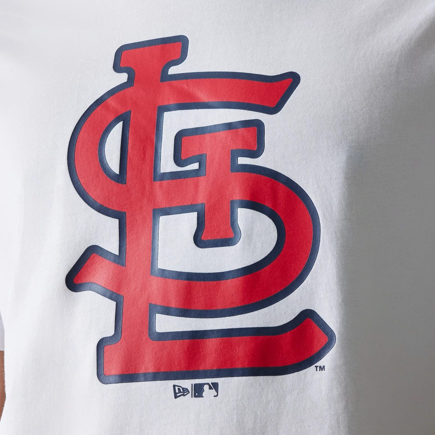 New Era St. Louis Cardinals MLB Regular White T-Shirt, front view showing a large red and blue outlined Cardinals logo centred on the chest, with small embossed New Era and MLB logos near the lower edge.