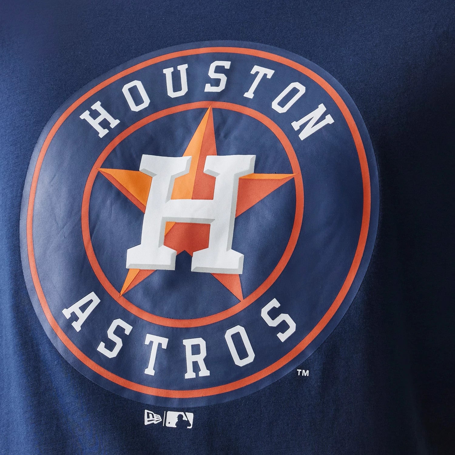 New Era Houston Astros MLB Regular Dark Blue T-Shirt, front view showing the large Houston Astros logo with a white debossed H over an orange star on the chest and a small white New Era logo near the bottom edge.