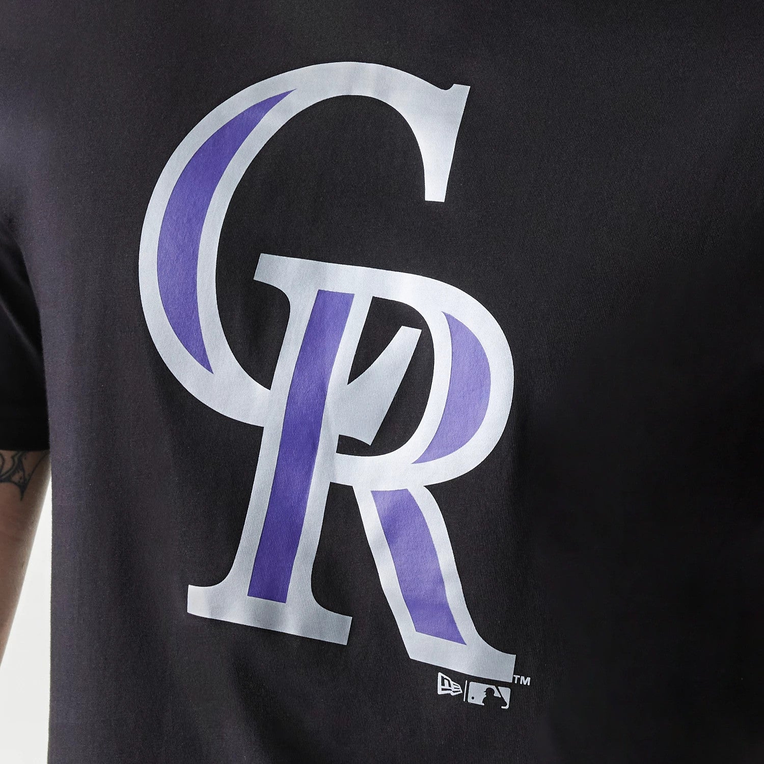 New Era Colorado Rockies MLB Regular Black T-Shirt, front view showing a large grey and purple CR logo centred on the chest, with a small raised New Era logo in white near the bottom right.