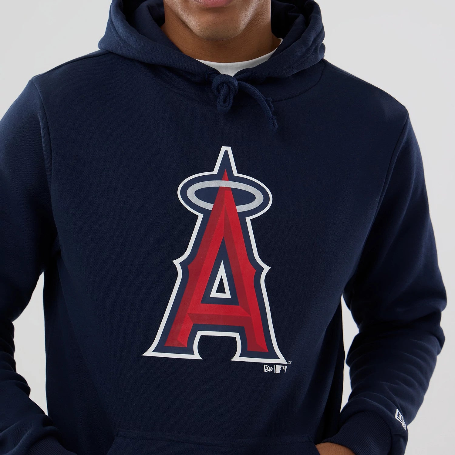 New Era LA Angels MLB Dark Blue Pullover Hoodie, front view showing the large red and white LA Angels logo emblazoned on the centre of the chest, a drawstring hood, and the New Era logo embroidered near the left wrist.