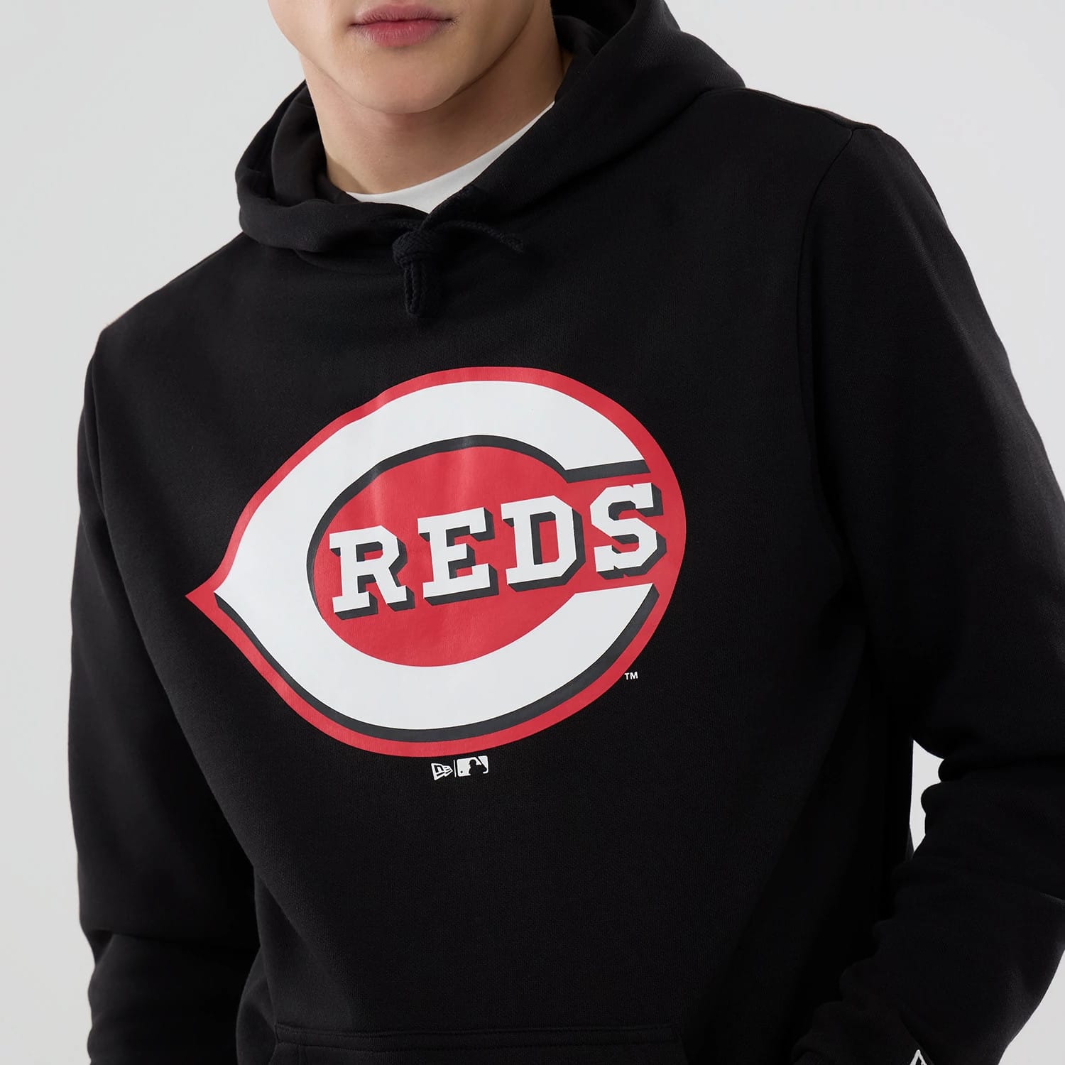 New Era Cincinnati Reds MLB Black Pullover Hoodie, front view showing the large red and white Cincinnati Reds logo on the chest, a drawstring hood and a small raised New Era logo on the left sleeve cuff.