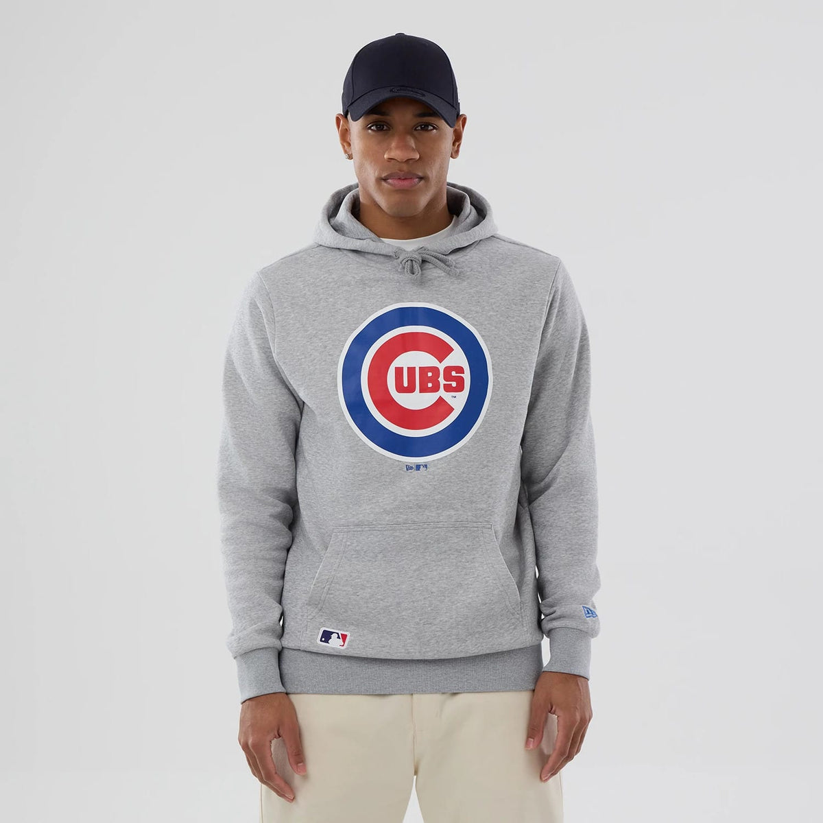 New Era Chicago Cubs MLB Grey Pullover Hoodie, front view showing a large circular Cubs logo in blue and red centred on the chest, a kangaroo pocket below, and a small MLB Batterman logo near the hem on the left side.