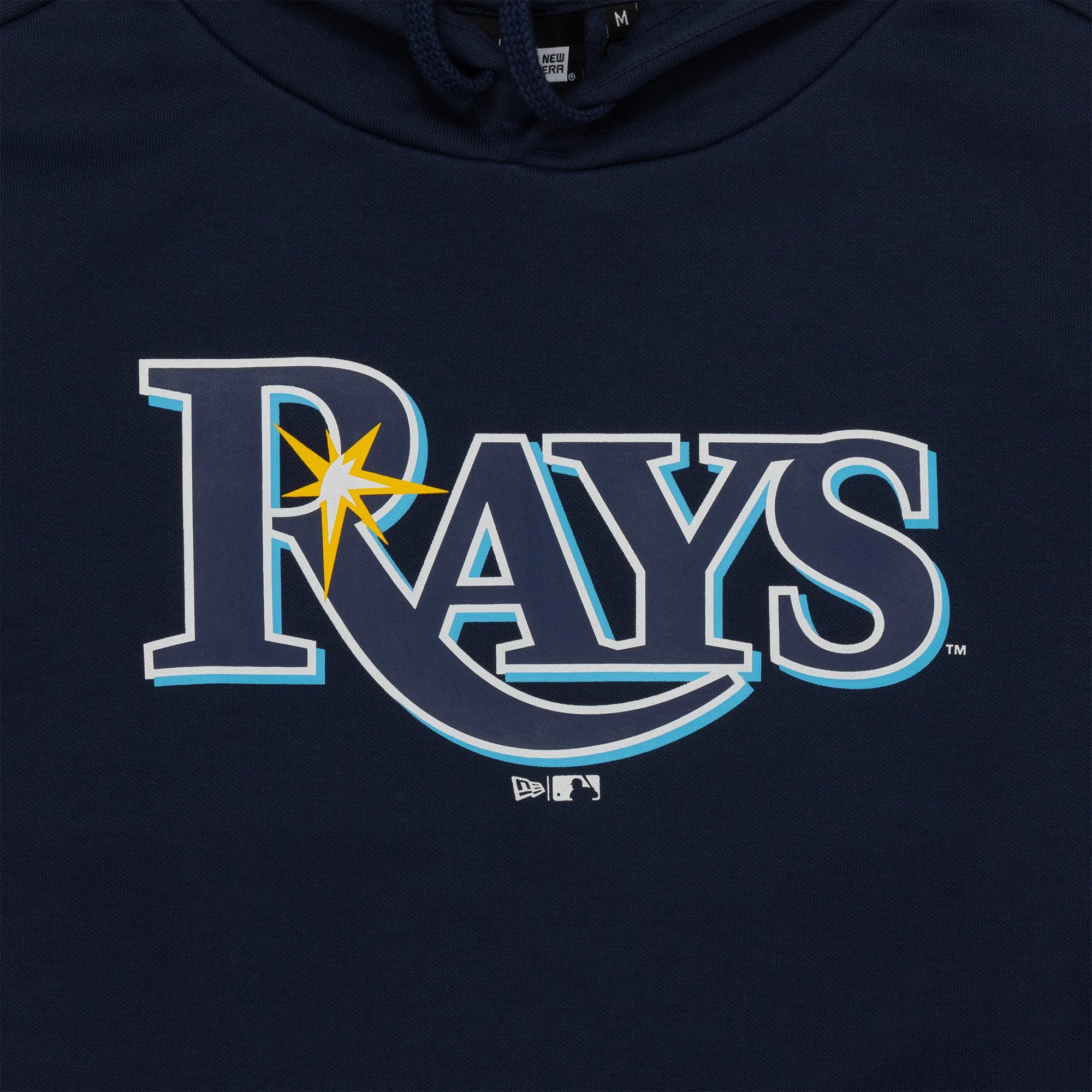 New Era Tampa Bay Rays MLB Regular Dark Blue Pullover Hoodie, front view showing a large printed Rays logo in white with a yellow starburst on the chest, a small embroidered New Era logo beneath it on a dark blue background.