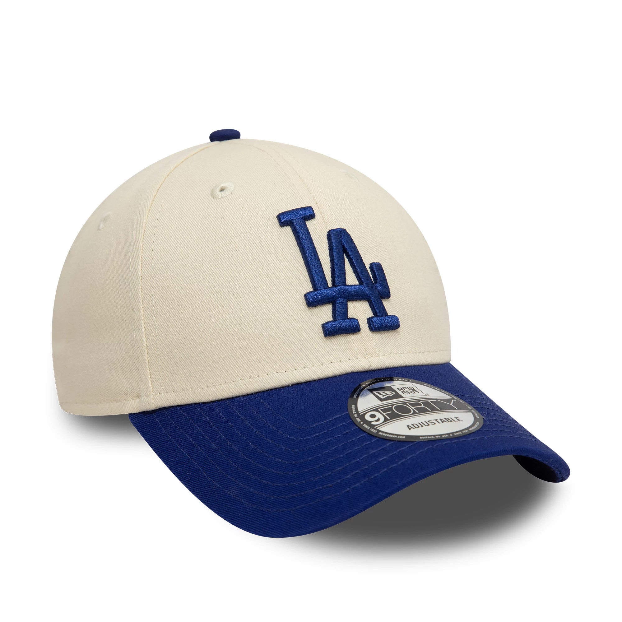 LA Dodgers Colour Block Cream New Era 9FORTY Adjustable Cap, three-quarter view showing the blue raised embroidered LA logo on the cream front panel, contrasting with a blue curved visor featuring the 9FORTY size sticker.