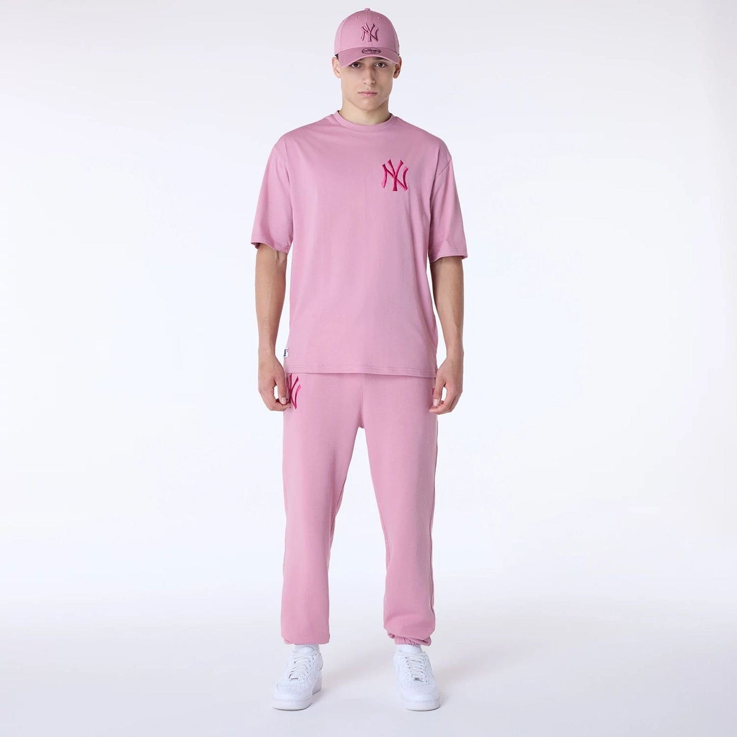 The Male model is wearing New York Yankees MLB League Essential Dark Pink Fleece Joggers 8