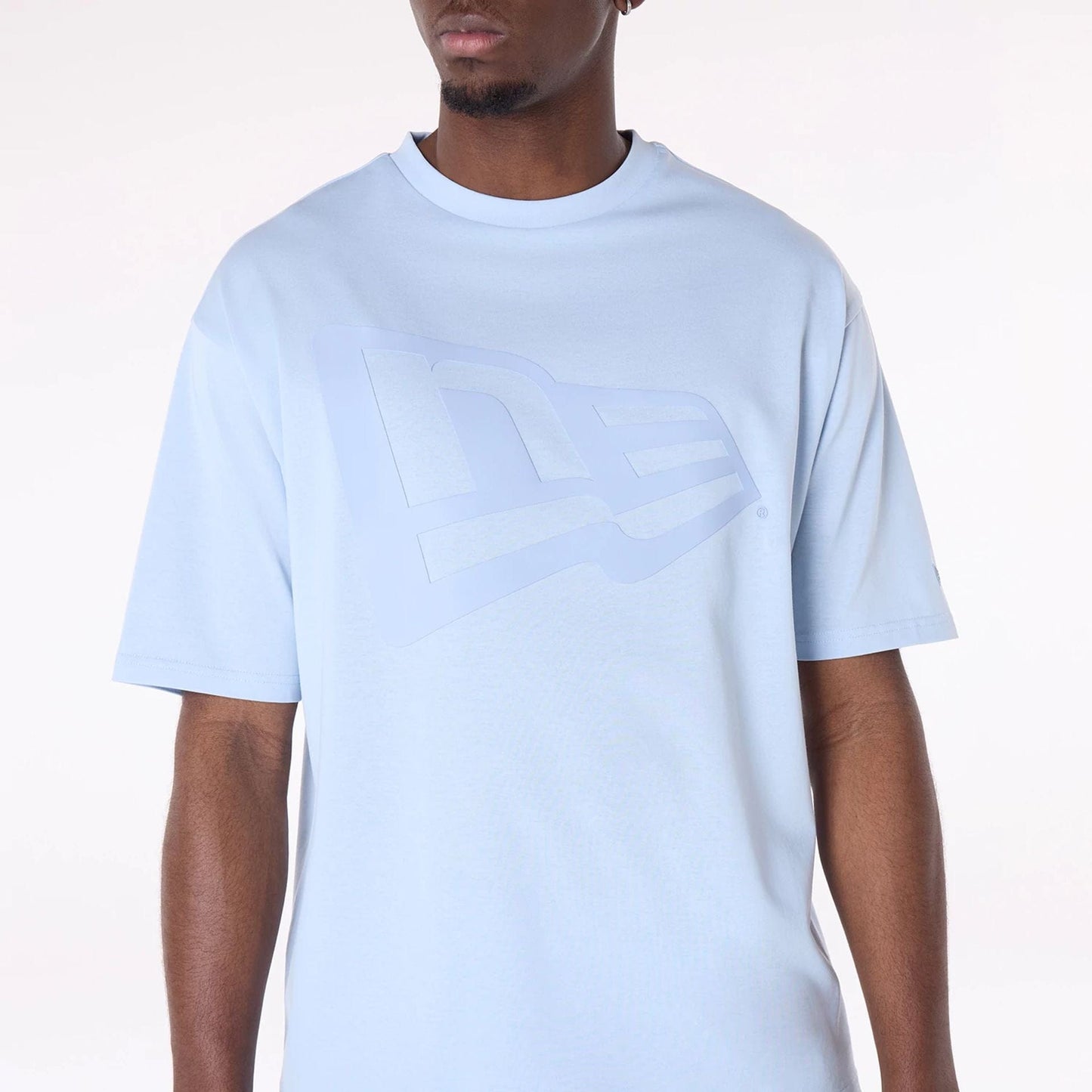The Male model is wearing New Era Flag Pastel Blue Oversized T-Shirt 8