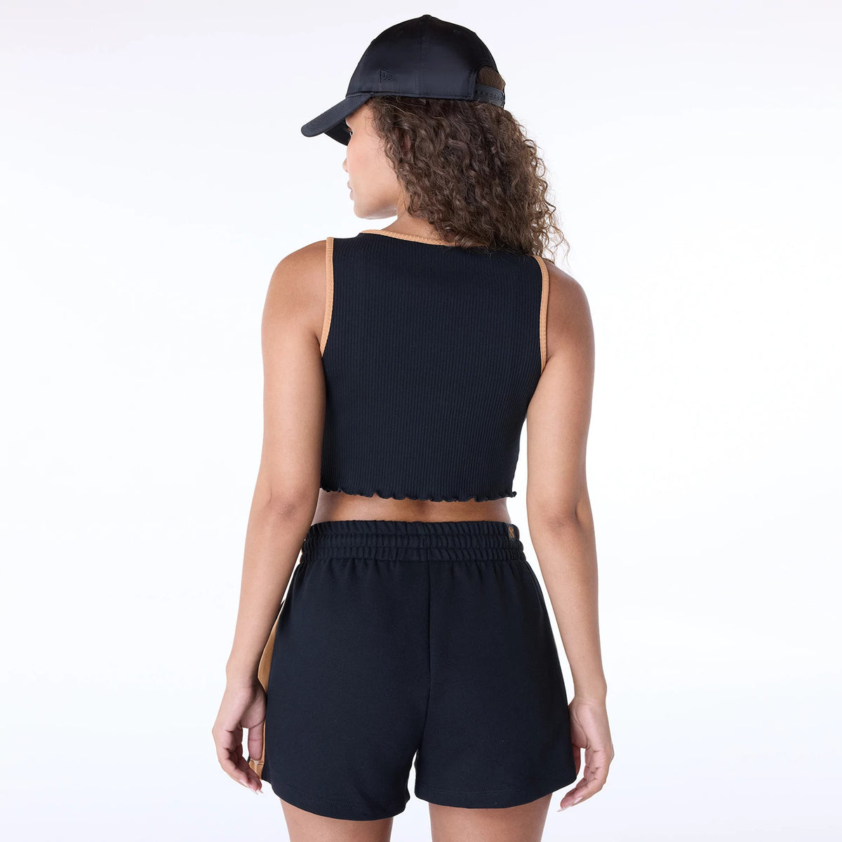 New Era New York Yankees Womens MLB Floral Black Vest, back view on a model wearing black shorts and a cap, showing ribbed texture and contrasting tan trim on armholes and neckline, styled in a casual sporty look.