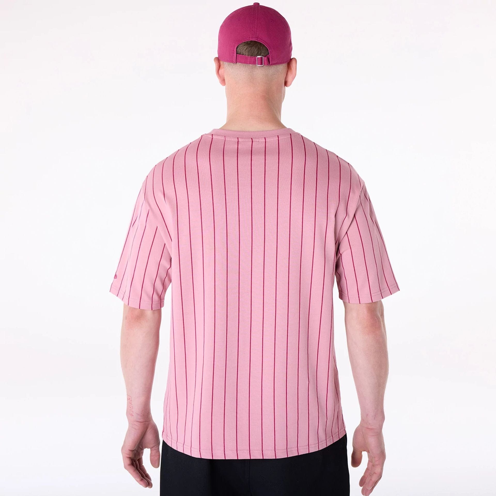 The Male model is wearing New Era Pinstripe Dark Pink Oversized T-Shirt 2