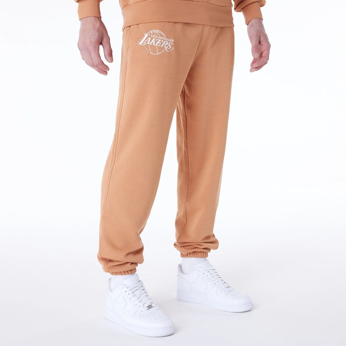 The Male model is wearing LA Lakers NBA League Essential Dark Beige Fleece Joggers 8